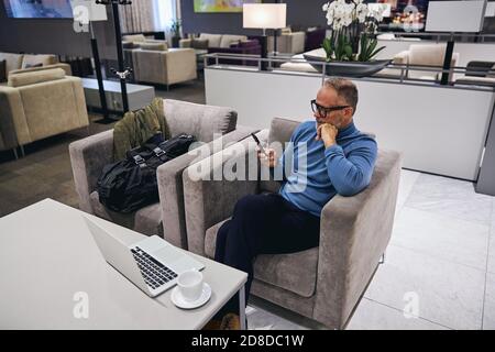 Man in eyeglasses reading a text message Stock Photo