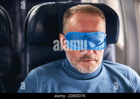 Man sleeping in the first class cabin Stock Photo