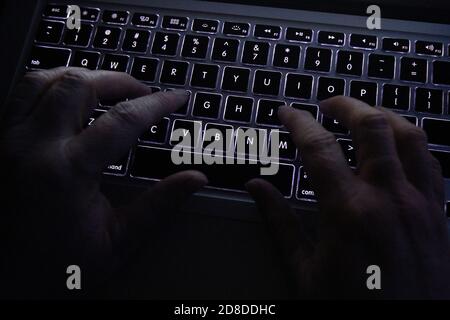 A person uses a laptop keyboard in Kingston, Ontario on Saturday, April 11, 2020. Stock Photo
