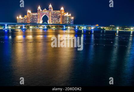 Atlantis, popular five star hotel in Dubai, UAE at night. Monorail leading to the hotel also can be seen in the picture. Outdoor. Stock Photo