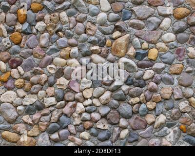 Cobblestone paving closeup, pebble way surface background Stock Photo