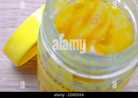 yellow english mustard in empty glass jar, norfolk, england Stock Photo