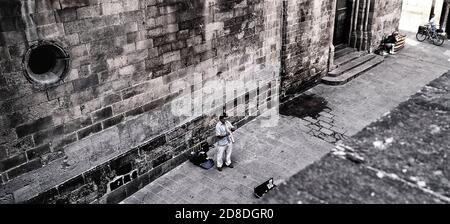 Street busker musician playing in the back streets of Barcelona. Catalan. Spain. Europe Stock Photo