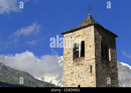 Bell tower of the Old Church of Macugnaga, Italy, with Monte Rosa in the background Stock Photo