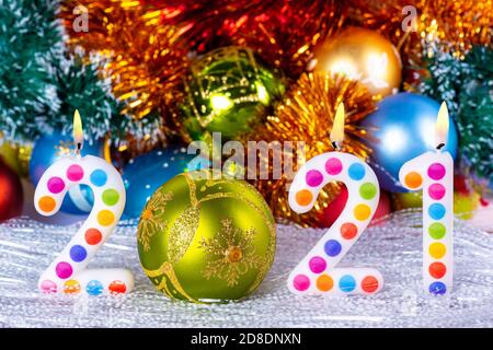 Four colorful candles write numbers flame Happy new year 2021 Stock Photo