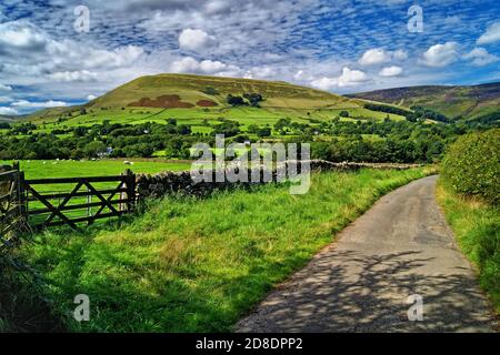 UK,Derbyshire,Peak District,Country Lane near Edale with Grindslow Knoll and Kinder Scout in the background Stock Photo