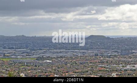 AUCKLAND, NEW ZEALAND - Aug 31, 2019: Remote view of Auckland city skyline from East Tamaki Heights through vast flat suburban area Stock Photo