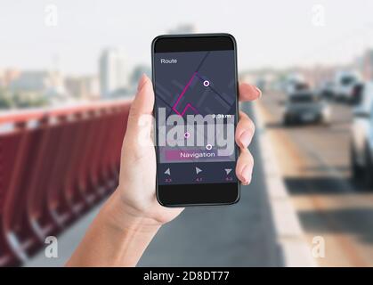 Woman Holding Smartphone Using Navigator App Walking In City Stock Photo