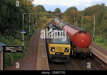 Colas diesel locomotive 70816 is running around its train of oil tankers that have been unloaded in the depot that is next to the station at Dalston. Stock Photo