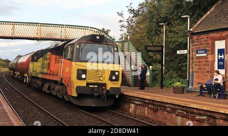 Colas diesel locomotive 70816 is leaving Dalston station with its train of empty oil tankers that have been unloaded in the depot next to the station. Stock Photo