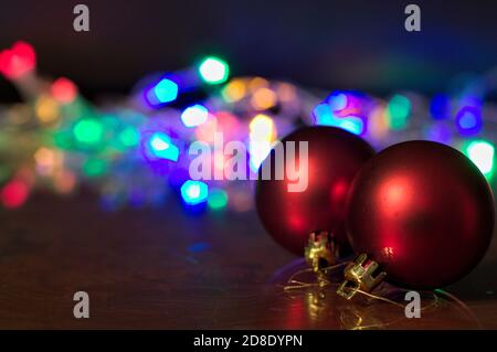 Image with copy space of some red balls to decorate a Christmas tree with defocused lights in the background Stock Photo