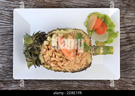 Thai royal pineapple fried rice on wooden table, selective focus Stock Photo
