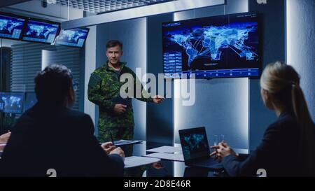 High-Ranking Military Man holds a Briefing to a Team of Government Agents and Politicians, Shows Satellite Surveillance Footage. Stock Photo
