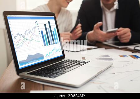 Business People Discussing Economics Strategy In Office, Focus On Laptop Stock Photo