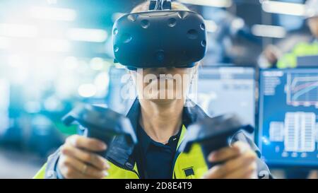 Portrait Female Mechanical Engineer Wearing Virtual Reality Headset and Using Controllers, She Uses VR technology for Industrial Design, Development Stock Photo