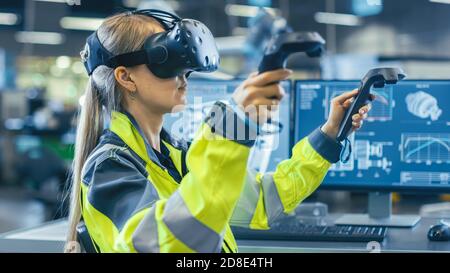 Female Industrial Engineer Wearing Virtual Reality Headset and Holding Controllers, She Uses VR technology for Industrial Design, Development and Stock Photo