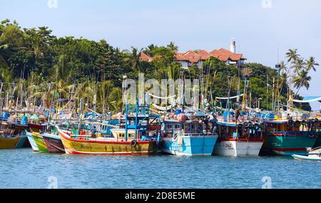 Mirissa, Sri Lanka - December 25, 2019: Fishing boats in the harbor of Mirissa, one of Sri Lanka top travel destinations. Stock Photo