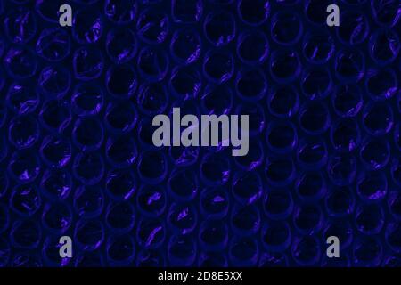 electric blue sparkling bubbles, brilliant plastic cellophane drops texture waste recycling background Stock Photo