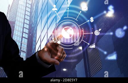 African american businessman presses on planet button on modern digital screen Stock Photo