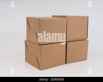 several cardboard boxes. Cardboard Boxes Stacked Against White Background. Stock Photo