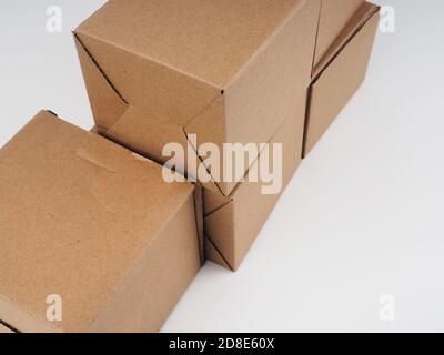 several cardboard boxes. Cardboard Boxes Stacked Against White Background. Stock Photo