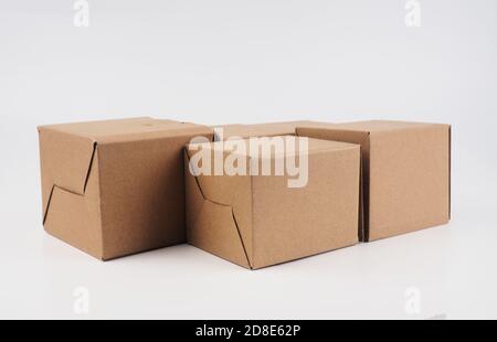 several cardboard boxes. Cardboard Boxes Stacked Against White Background. Stock Photo