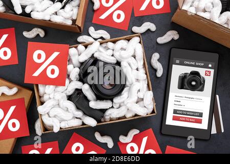 Online shopping of digital camera and other electronic products during sales period concept. Tablet computer with online shop app on screen surrounded