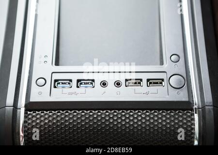 Black pc tower case with usb connection sockets, power and reset buttons on top of box, close-up view Stock Photo