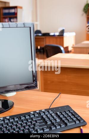 Out of work business office with turned off computers, empty workplaces, nobody Stock Photo