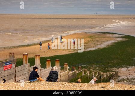 UK, Kent, Whitstable, Tankerton, visitors on the street, natural feature stretching out to sea Stock Photo