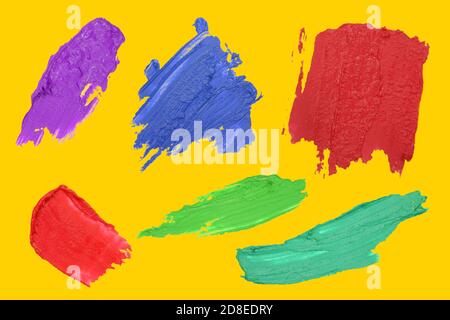 Volumetric strokes of paint isolate on a yellow background. Set of abstract acrylic color brush stroke. Stock Photo