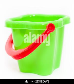 Green plastic children bucket with red handle on a white background Stock Photo