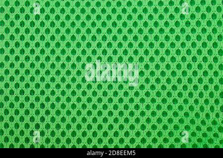 green special textile mesh background. Polyester mesh with foam rubber for the manufacture of backpacks. Lining mesh with foam for the inside of a bag Stock Photo