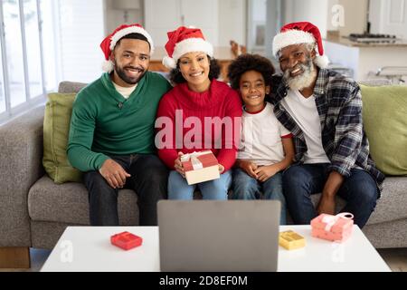 Portrait of Multi-generation family sitting on couch at home Stock Photo