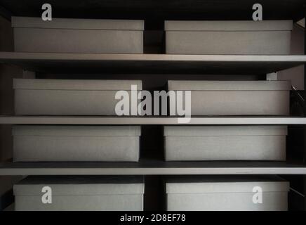 Shelves with cardboard storage boxes in black for office or home close up Stock Photo