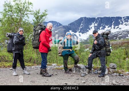 Team of climbers showing thumbs up, portrait of senior couple with teenage and adult sons, people dressing mountaineering outfit Stock Photo