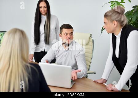 Meeting of female employees and young CEO in office Stock Photo