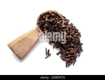 whole cloves in a wooden spoon isolated on a white background Stock Photo