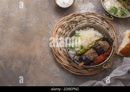 Eggplant kebabs on skewers with tomato and peppers, copy space Stock Photo