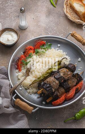 Tasty aubergine kebabs with rice pilav, copy space Stock Photo