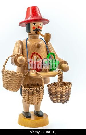 Closeup of a original handcarved wooden German Christmas Smoking Man figurine on a white background Stock Photo