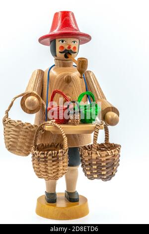 Closeup of a original handcarved wooden German Christmas Smoking Man figurine on a white background Stock Photo