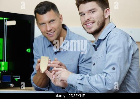 workers showing product created by 3d printer Stock Photo