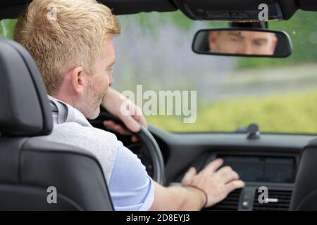 male driver using touchscreen in car Stock Photo