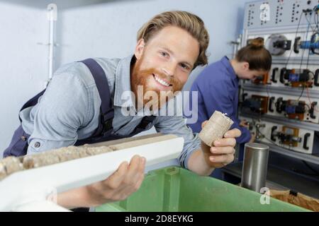 handsome young man working in the furniture factory Stock Photo