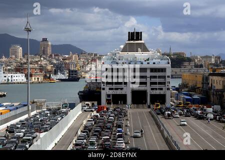 Genoa, Italy. 30 Aug 2020. Terminal ferries in Genoa port. Cars waiting to board a big ferry boat to Sardegna island during a summer day. Genoa city. Stock Photo