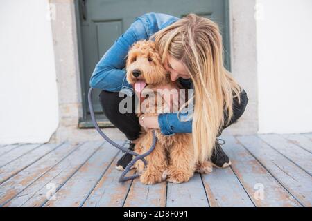 Labradoodle Dog and woman outside on balcony Stock Photo