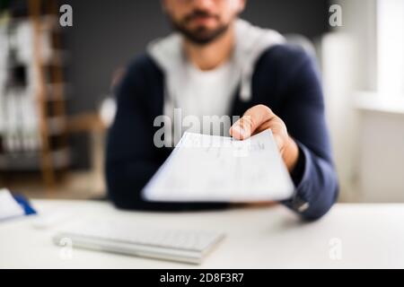 Man Giving Payroll Compensation Paycheck Or Cheque Stock Photo
