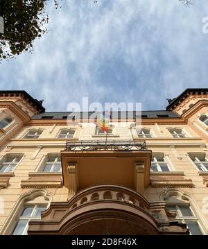 rainbow flag on the balcony of an old house against the blue sky Stock Photo