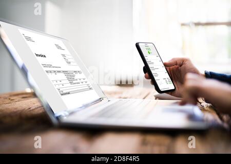 Digital Invoice Document On Tablet Or Laptop. Accountant Tech Stock Photo